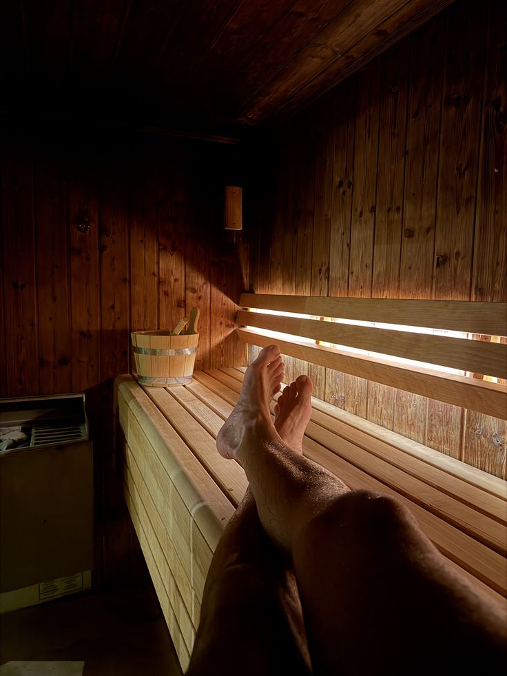 Warmly lit sauna interior with timber benches